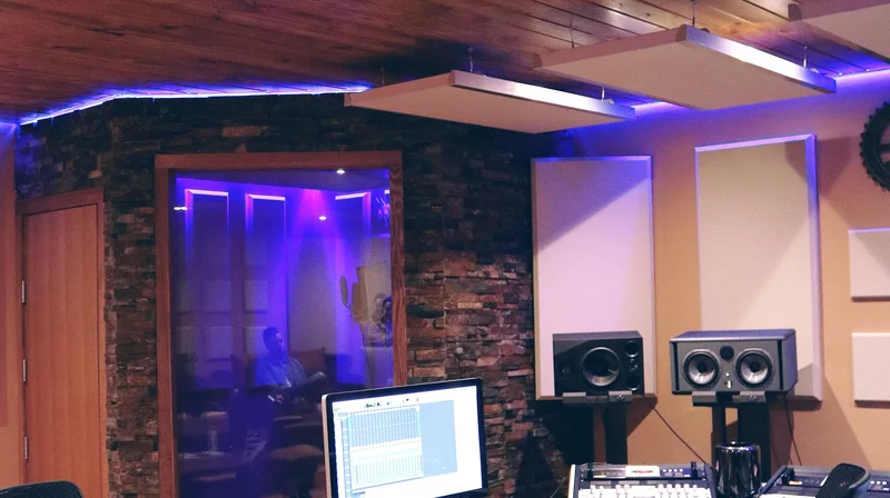 a home recording studio with monitor speakers and a mixing setup